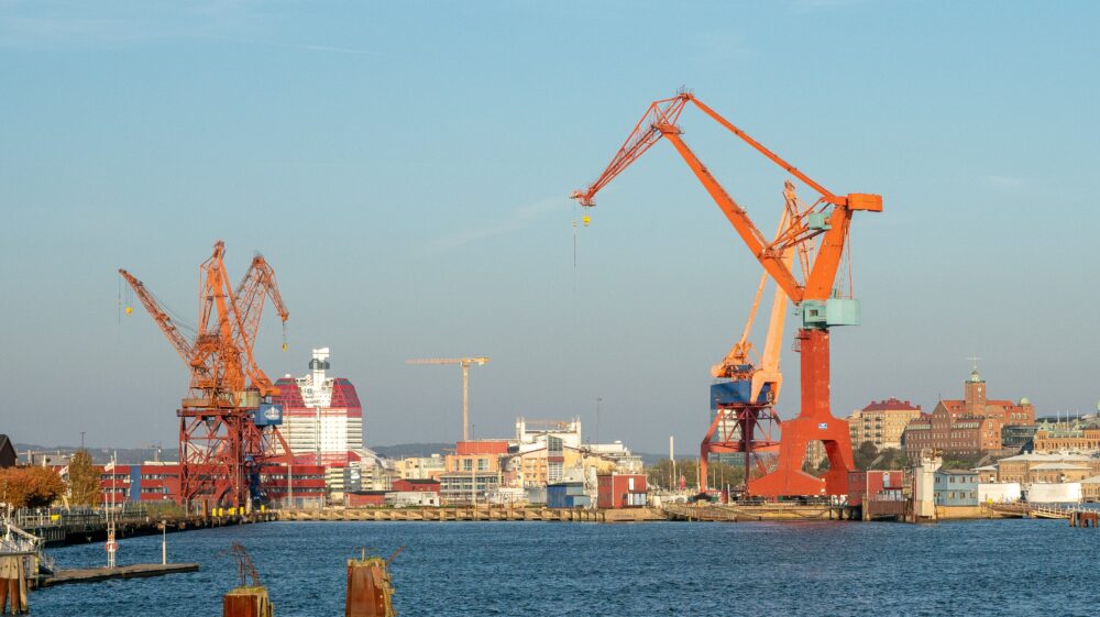 Red cranes and cargo ships at Gothenburg Harbour