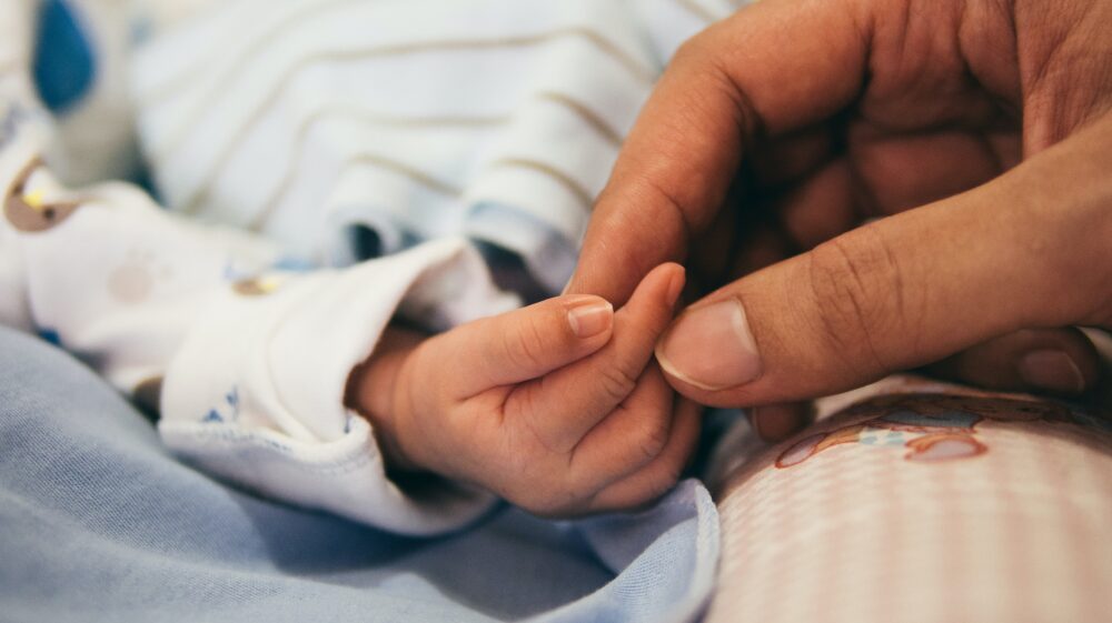 Close-up of mother and newborn infant's hands, Jakarta, Indonesia, August 2016