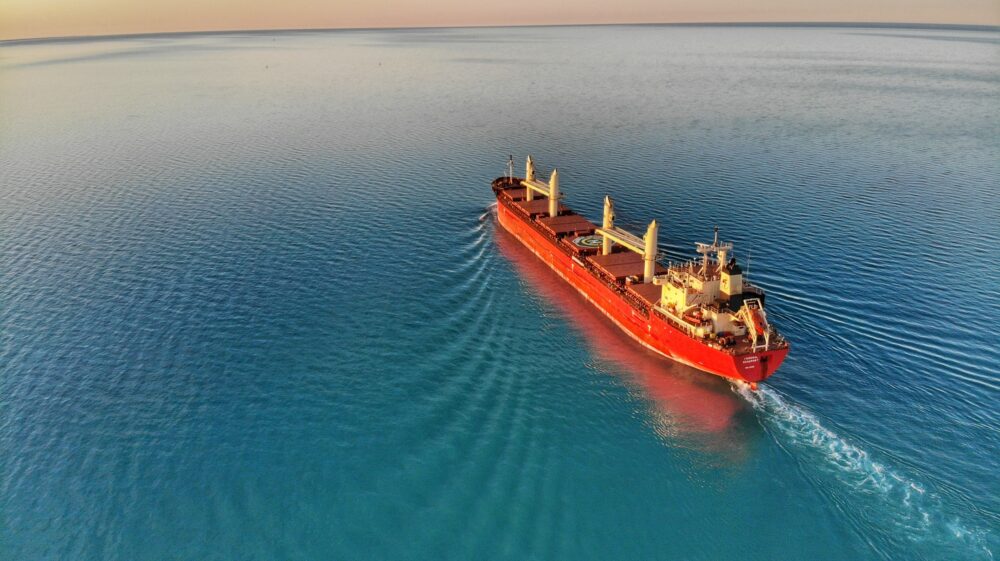 Red-coloured bulk freighter Federal Beaufort leaves the St. Clair River and heads out into clear blue Lake Huron, Michigan, US