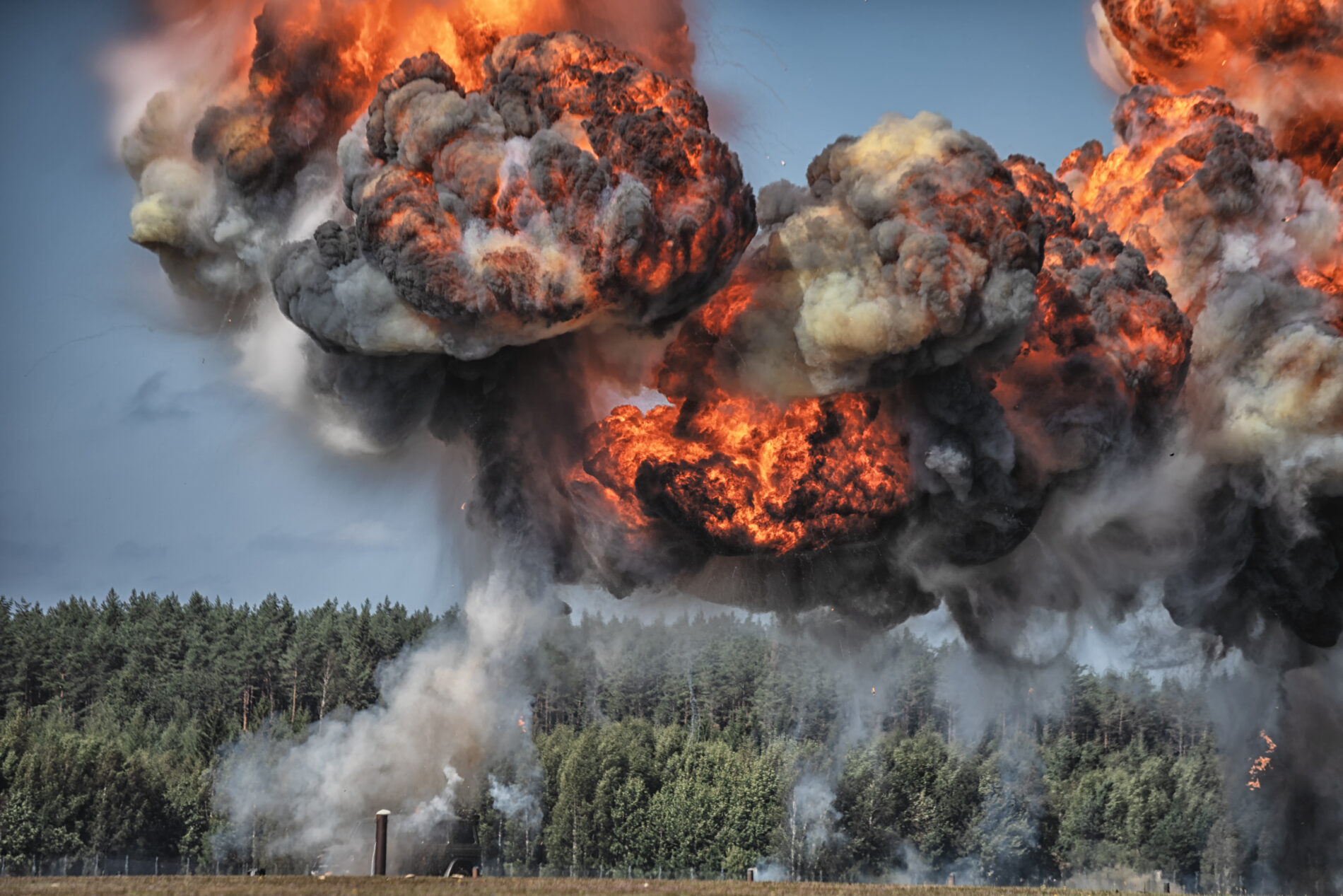 Intense explosion with fire and black smoke and sky in background, Sweden
