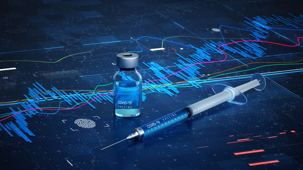 Digitally generated image of syringe and bottle with Covid-19 vaccine on dark blue data surface of Covid-19 vaccine economy chart, Germany
