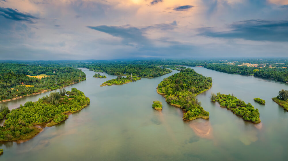 Aerial view of mangrove islands near Kundapura, Karnataka, India at dusk under partly cloudy sky