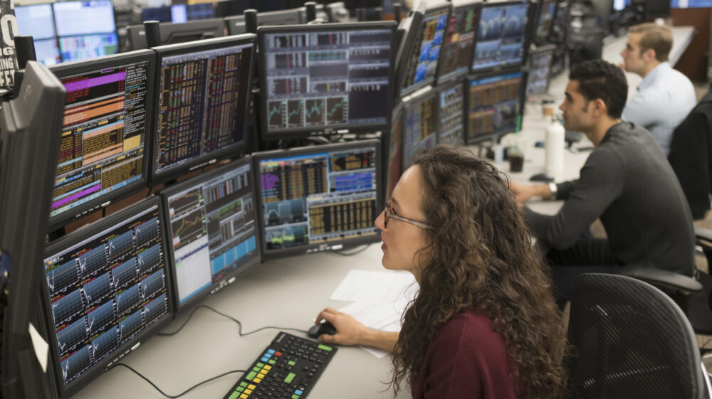 Young traders analyzing computer data