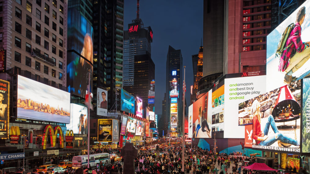 Times square lighting up at night showing a version of prosperity. human social redefine prosperity