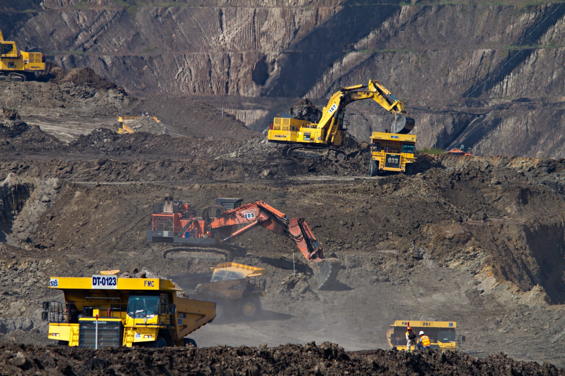 Yellow and red excavators at mining site photographed while on assignment for Indonesia's largest coal mining company, South Kalimantan