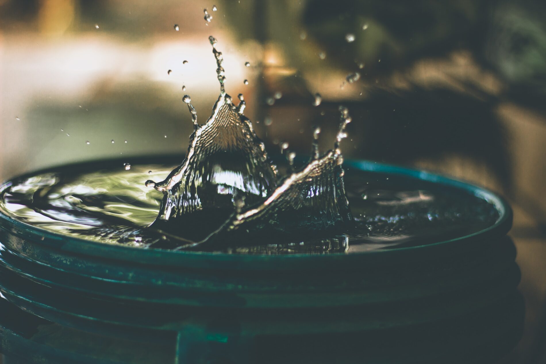 Water splashing out of container, India