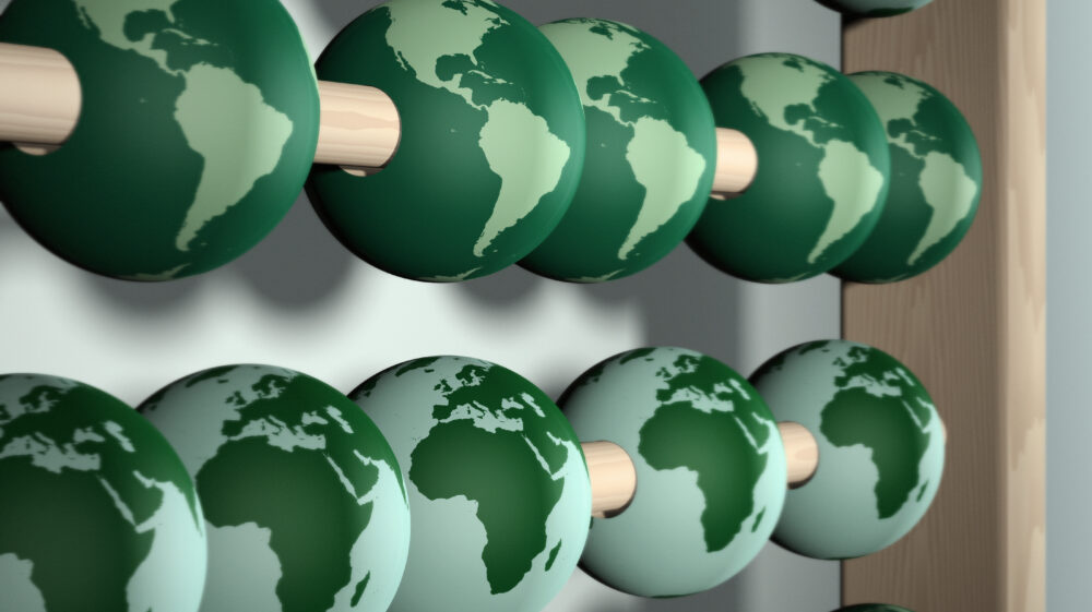 Conceptual illustration of abacus used to calculate cost of environmental damage on Earth. With shallow DOF using Earth map from NASA