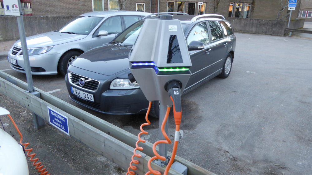 Charging electric vehicle in parking lot in Sweden