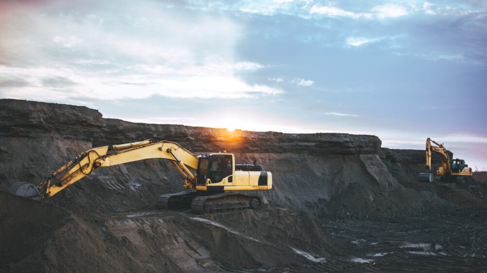 Yellow excavator in mining surroundings