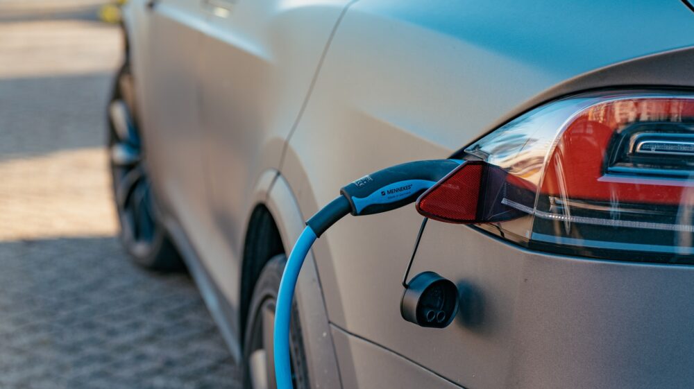 Grey electric car at charging station