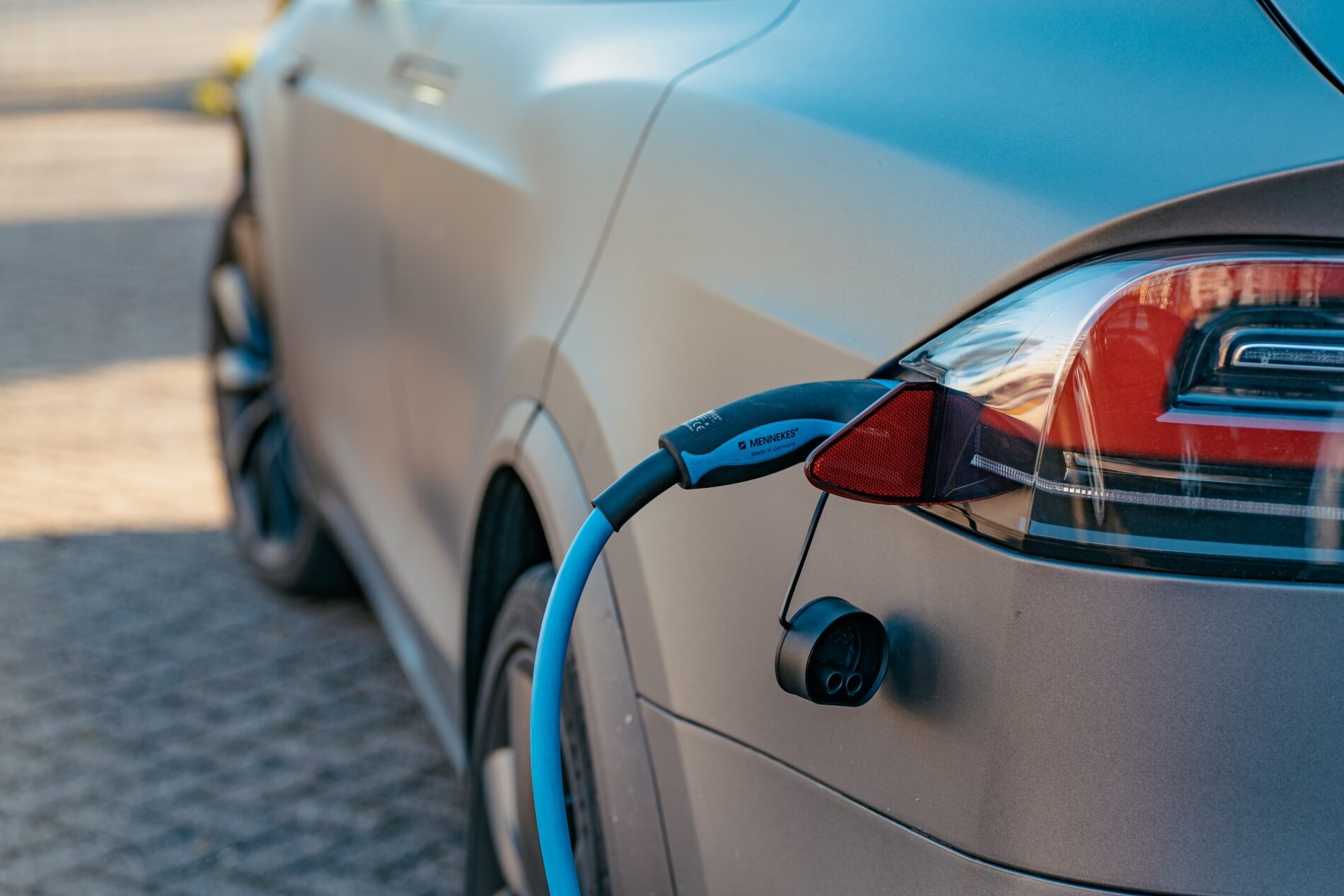 Grey electric car at charging station