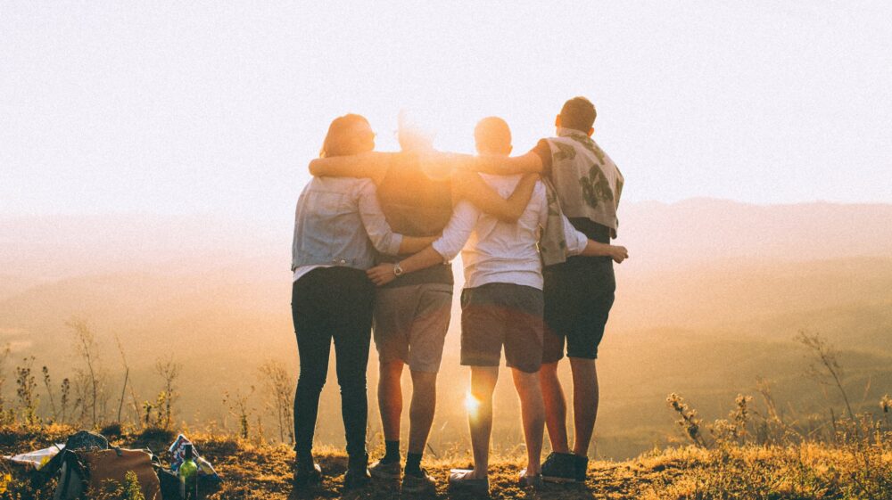 Youth from behind holding each other