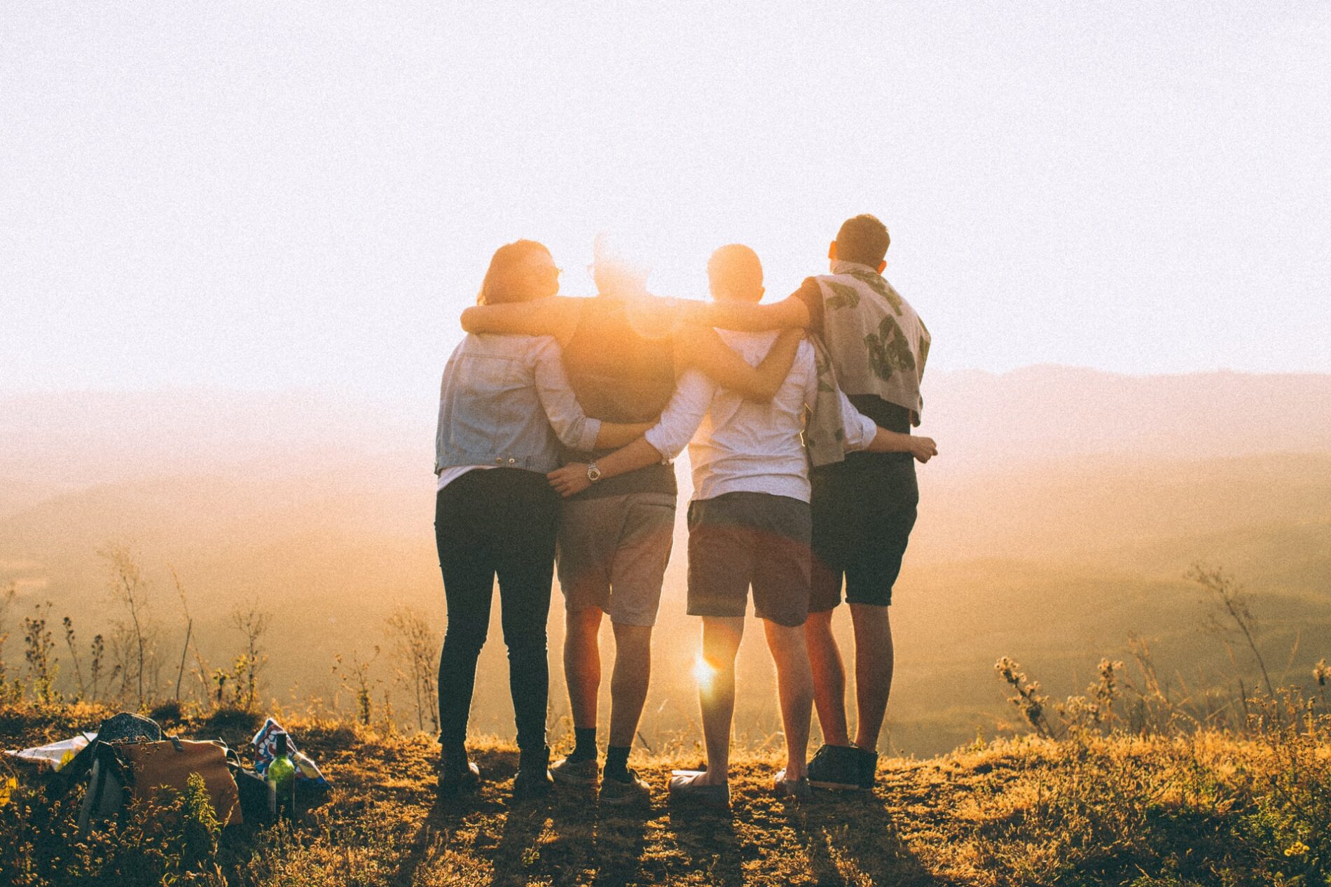 Youth from behind holding each other
