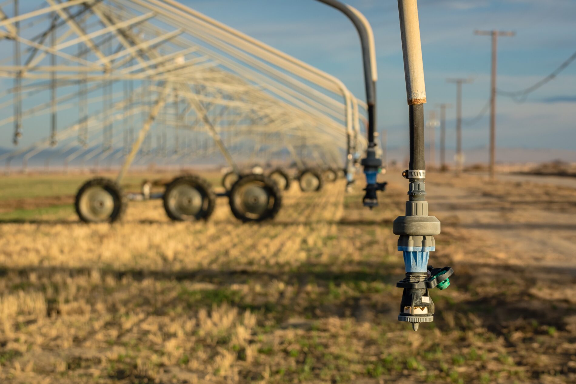 Center-pivot irrigation system hovers over dry agricultural field, Southern California, US