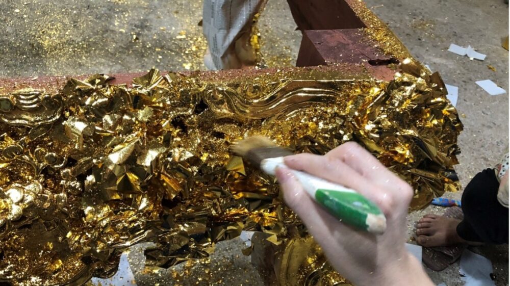 Women do the task of gold plating. The fine gold dust gets blown everywhere around the room and the ground