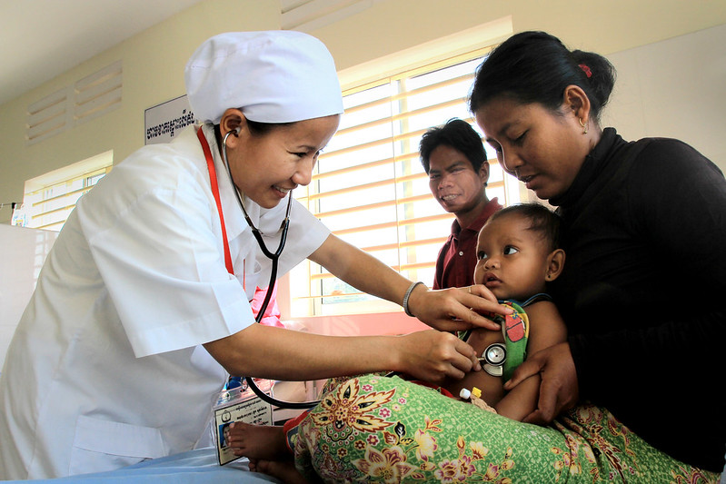 A trained medical staff listens to the heartbeat of an infant at 16 Makara hopsital in Preah Vihear, Cambodia