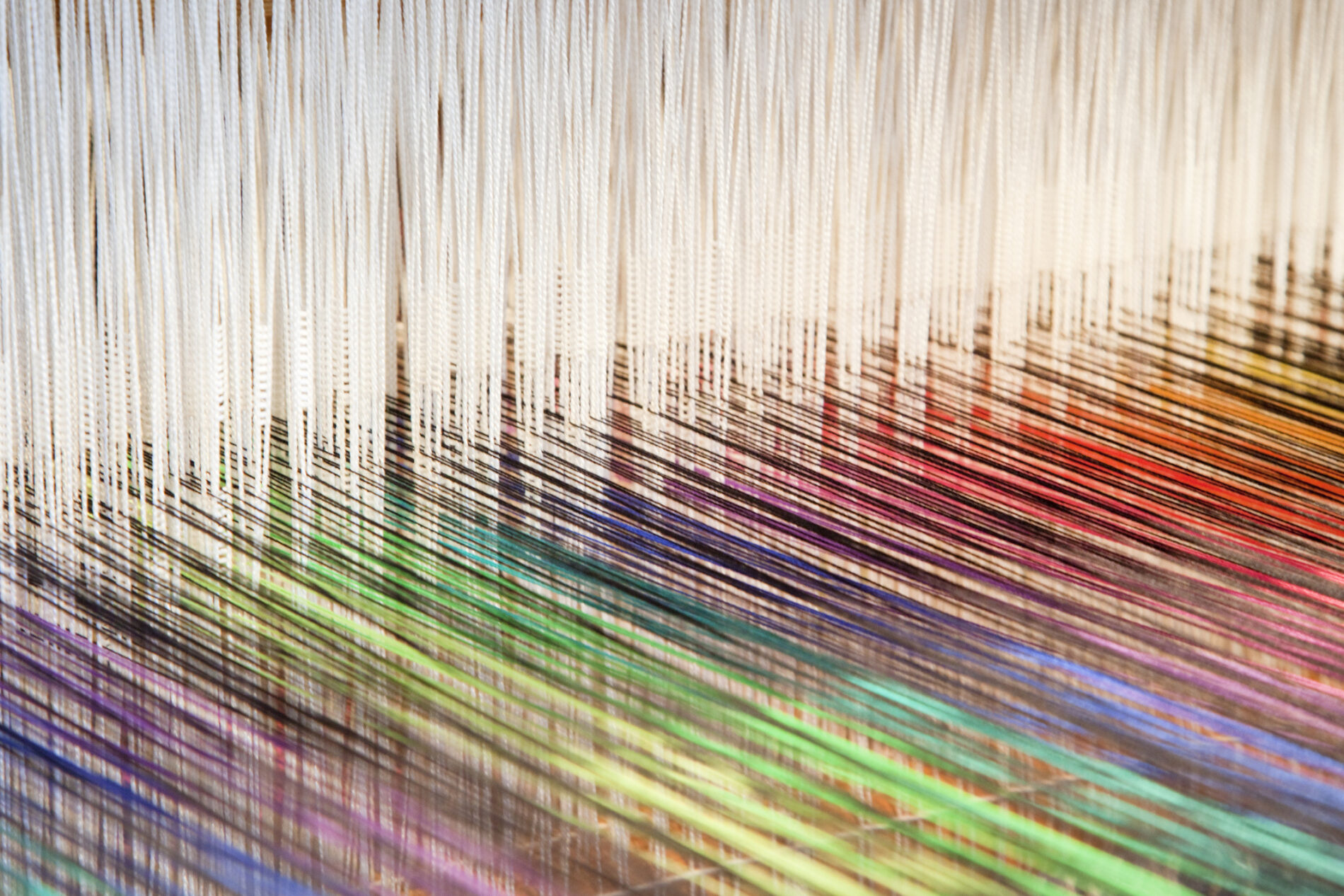 Colourful threads on an old-fashioned loom