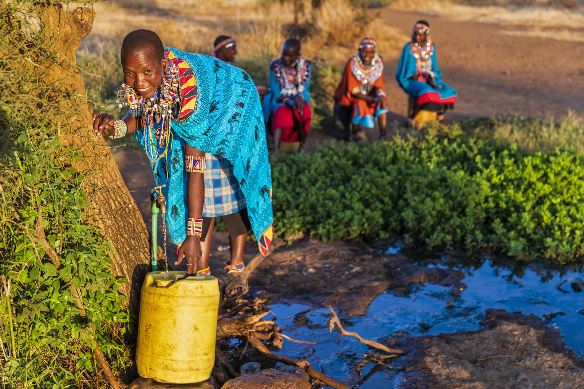 African woman from Maasai tribe collecting water, Kenya, East Africa