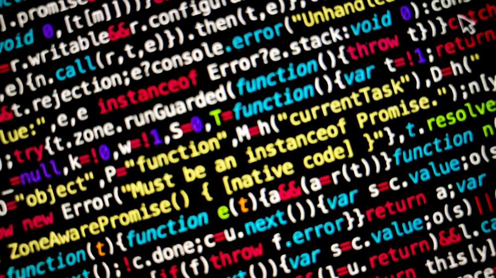 Colourful source code in code editor with black background