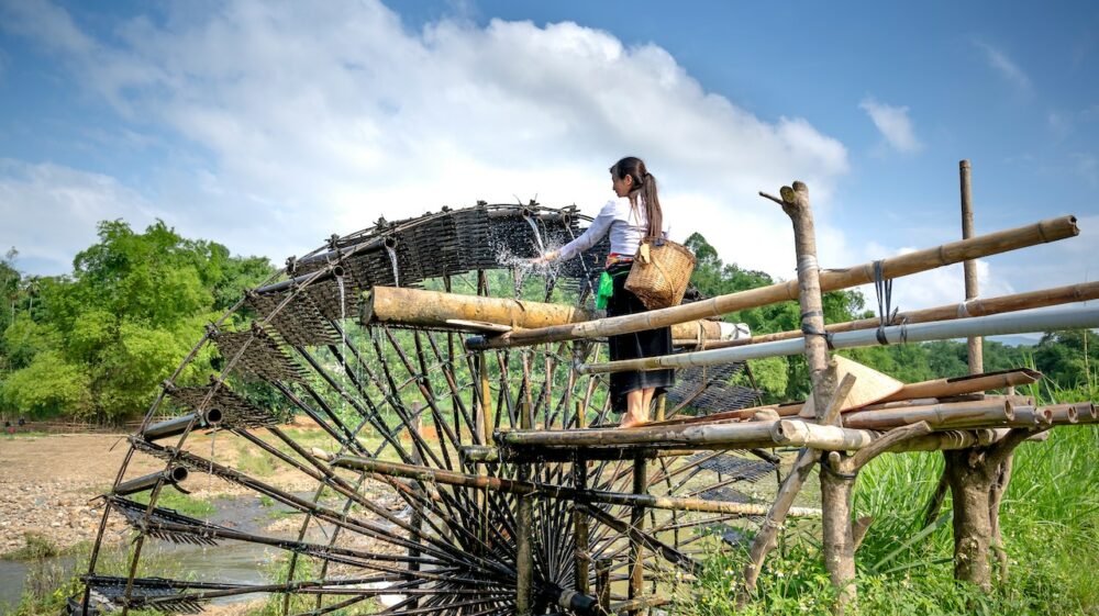 Woman washing hands in water wheel