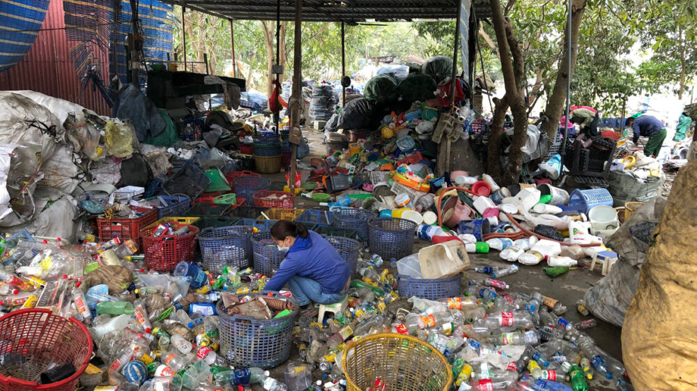 woman sorting plastic in a craft village in Viet Nam