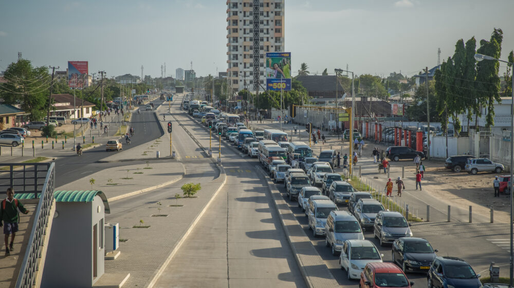 Trafic congestion on a major road in the city of Dar Es Salaam, and a new bus lane and bus stop, investment in the transport infrastructure