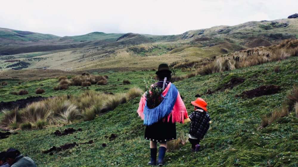 Guangaje, Ecuador: After the blessing of a water spring, a mother with a child returns home