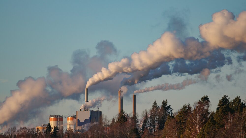 Smoke rising towards the sky from the chimneys of a paper mill in Sweden