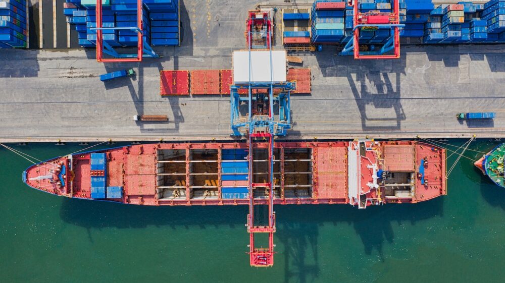 Aerial Photo of Cargo Ship Near Intermodal Containers