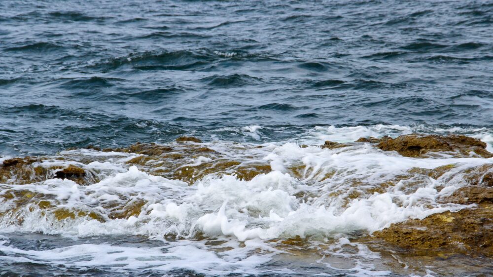 Ocean waves covering a rock