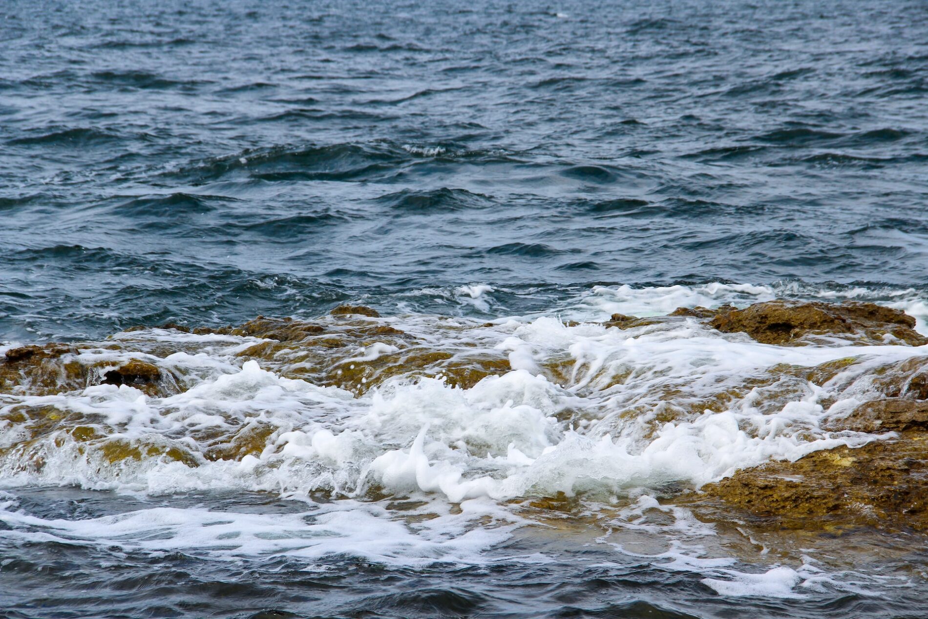 Ocean waves covering a rock