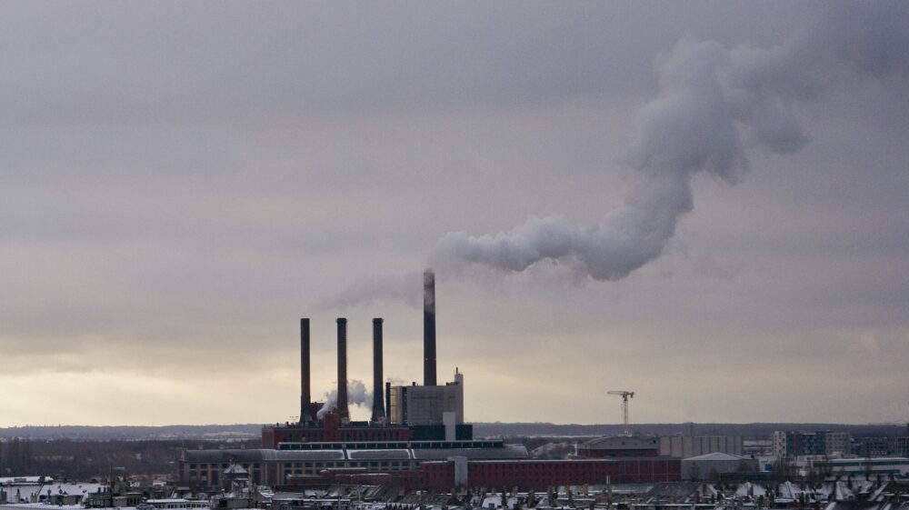Factory emitting smoke in winter