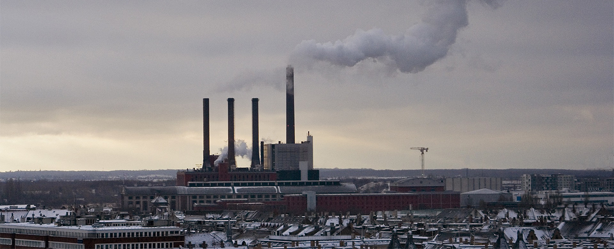 Factory emitting smoke in winter