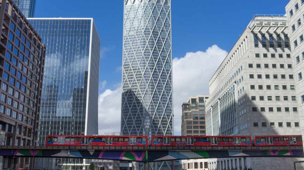 Newfoundland skyscraper in Canary Wharf with a Docklands Light Railway train below. London, UK, 20 August 2020