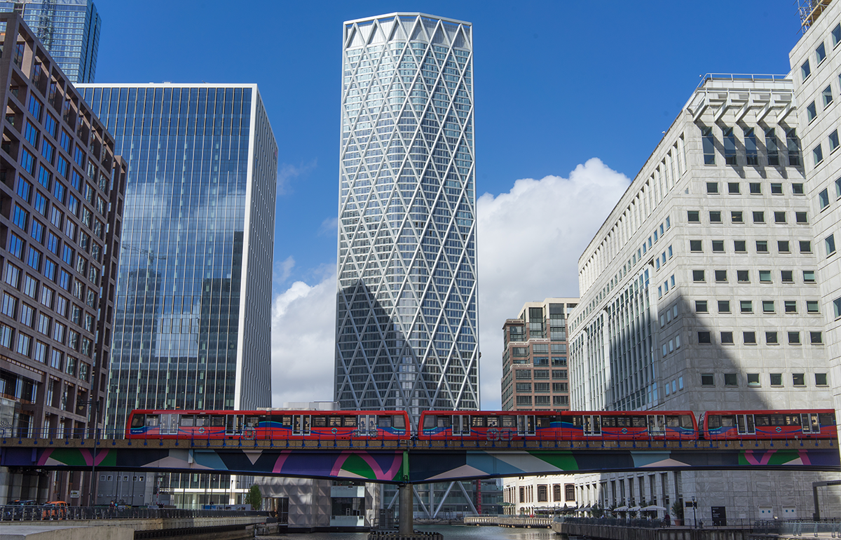 Newfoundland skyscraper in Canary Wharf with a Docklands Light Railway train below. London, UK, 20 August 2020