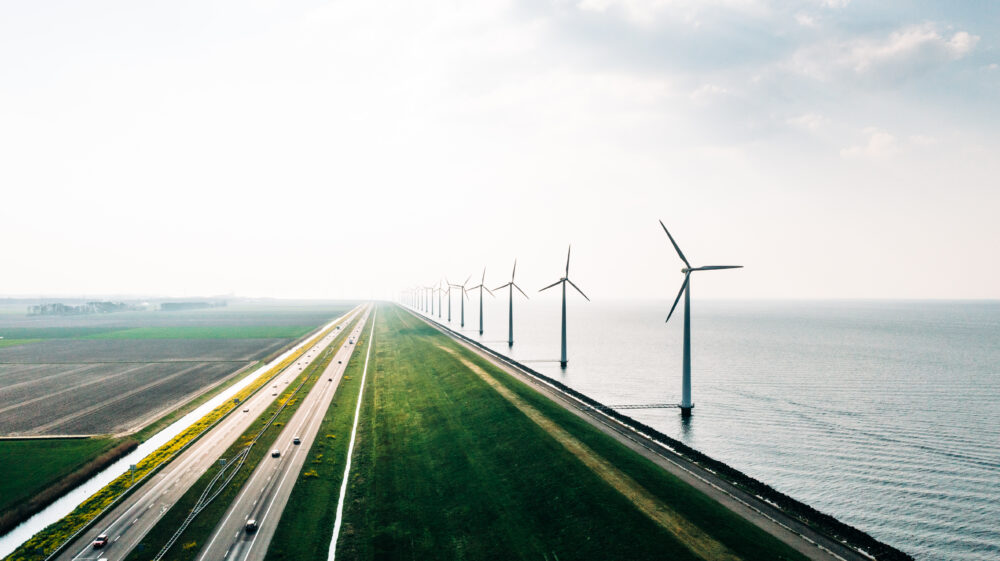 A dutch energy farm on the coast. An aerial view of wind turbines, Holland - stock photo