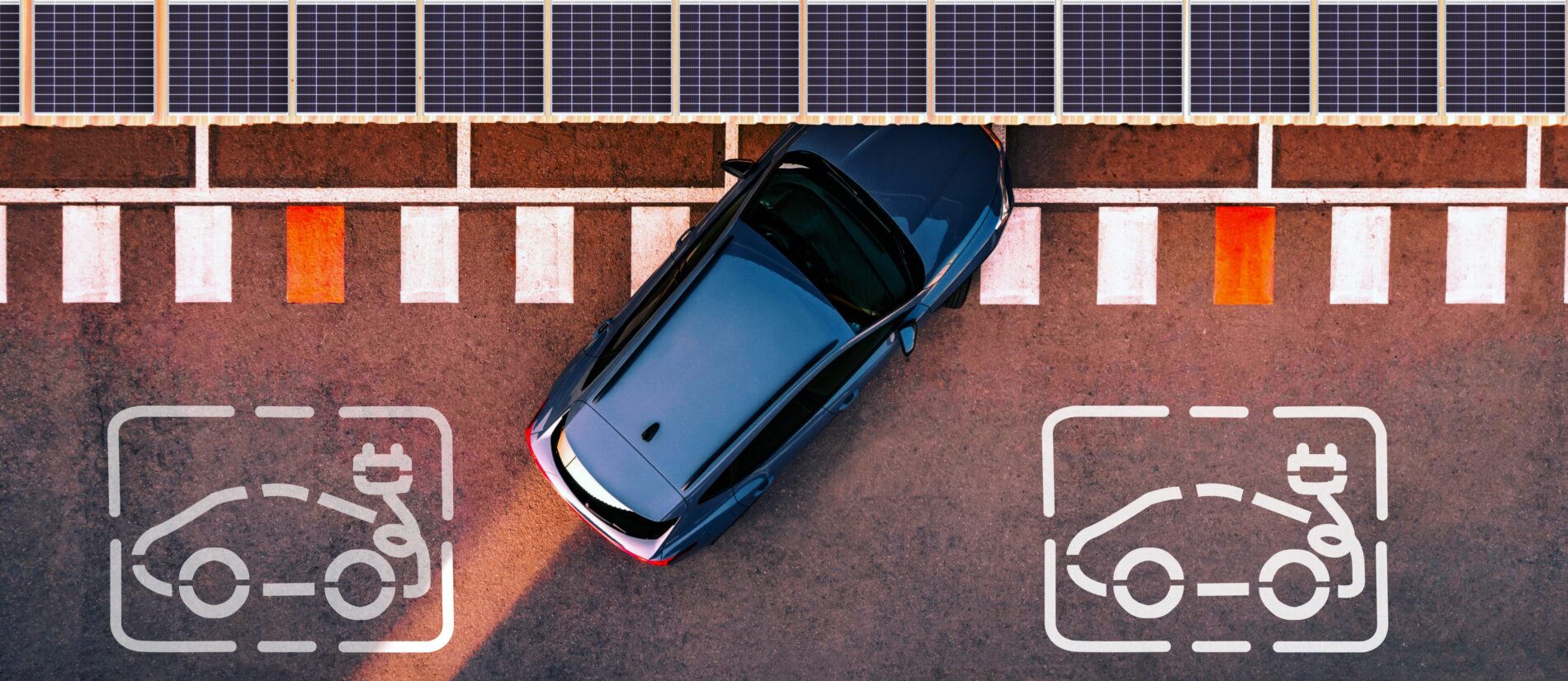 Aerial view of electric car parking in charging station with solar panels.