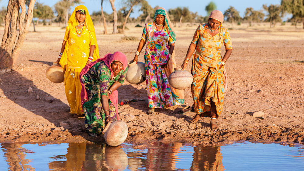 Women collecting water from a lake in Rajasthan, India.