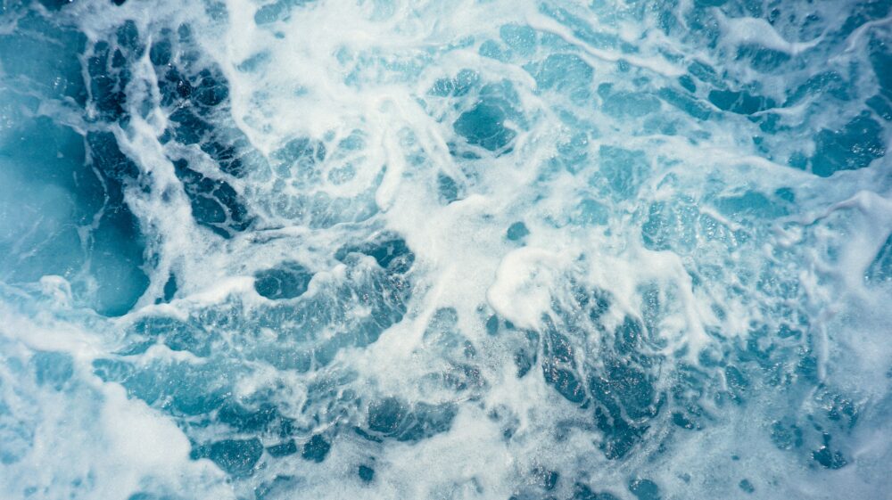 aerial view of blue crashing waves in the sea