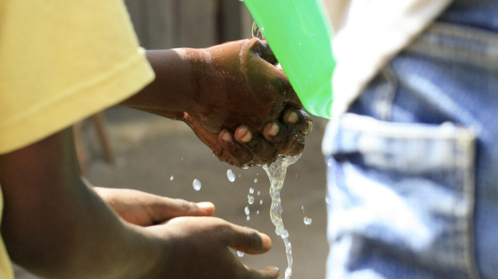 Children wash their hands before eating in Tanzania.