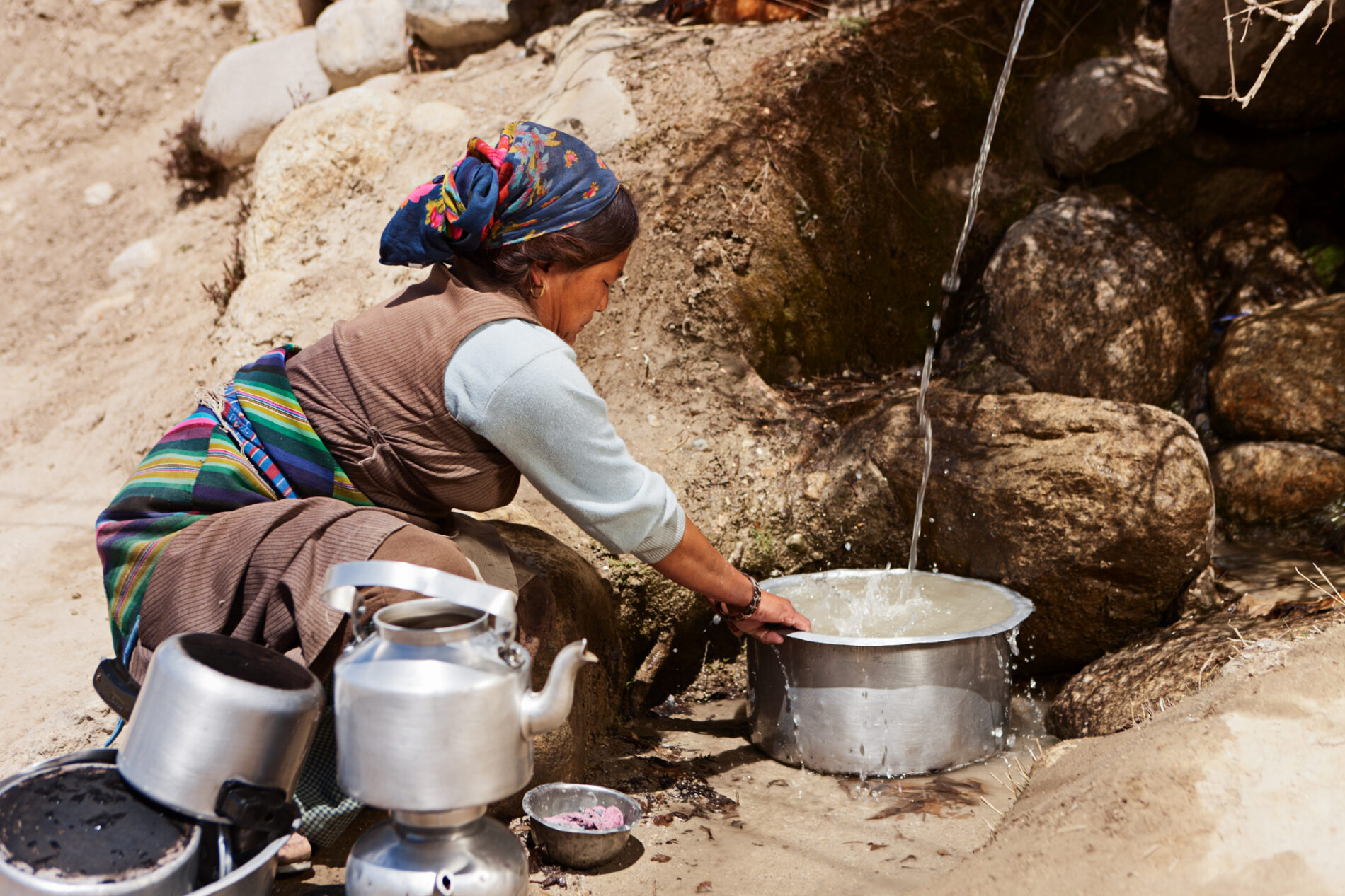 Tibetan woman washing dishes near Lo Manthan in Mustang. Mustang