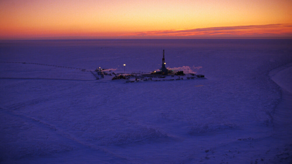 Oil well in frozen swath of Prudhoe Bay, Alaska, before a twilight sky