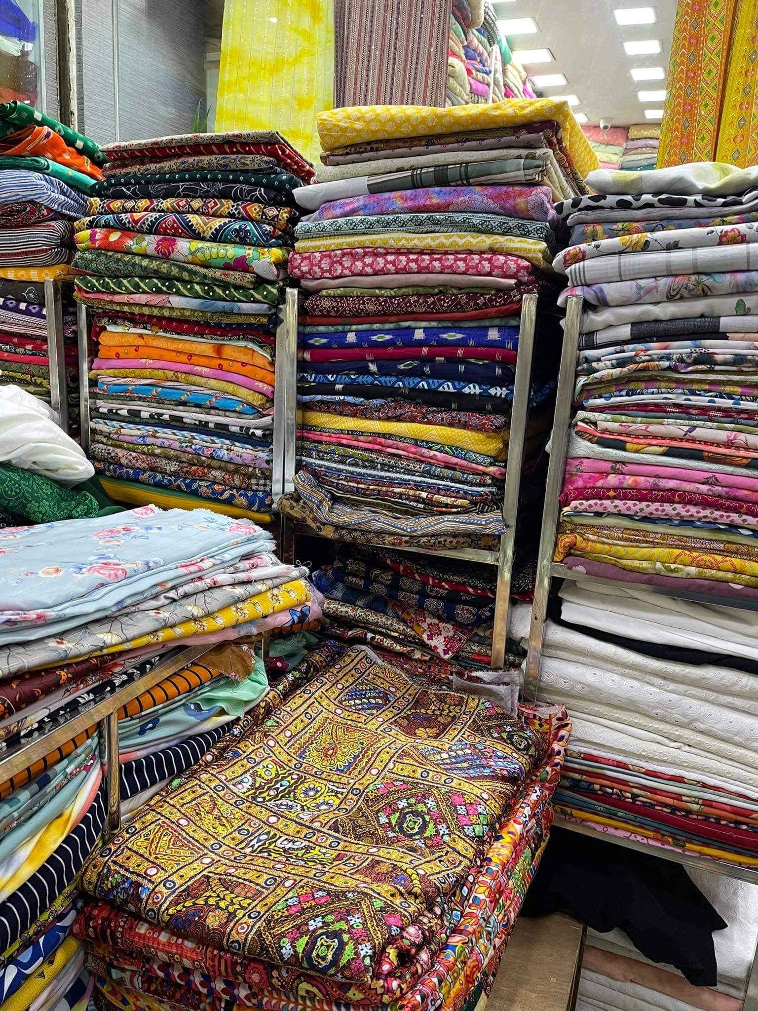 stacks of fabrics for sale in India, by Jaee Nikam / SEI Asia