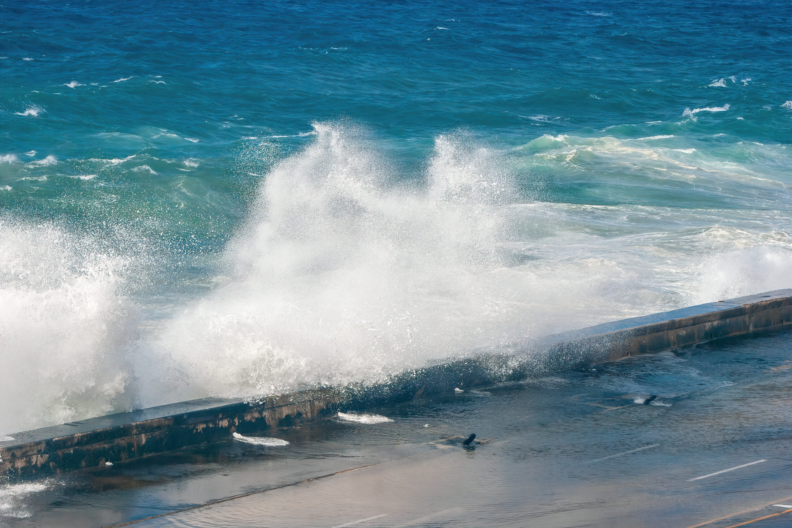 Violent waves crashing against seawall