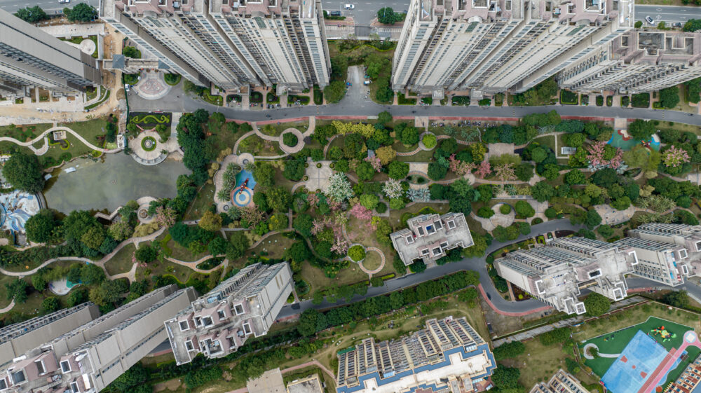 Top view of real estate buildings and green space in modern city
