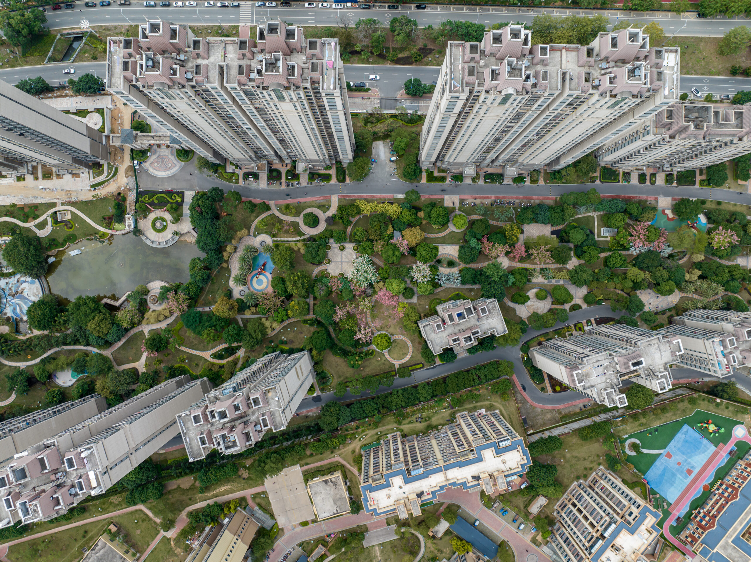 Top view of real estate buildings and green space in modern city