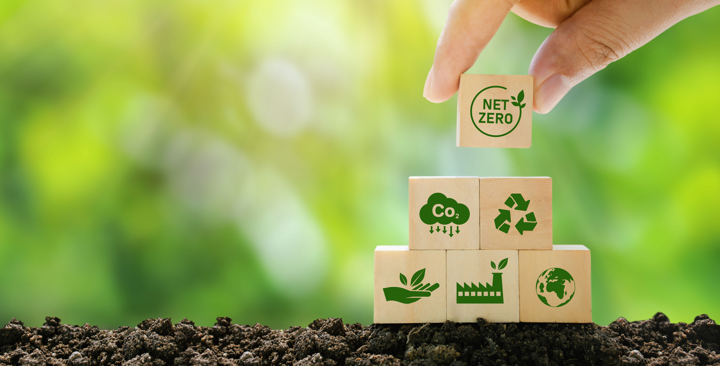 Wooden blocks by hand with green net center icon and green icon on gray background.