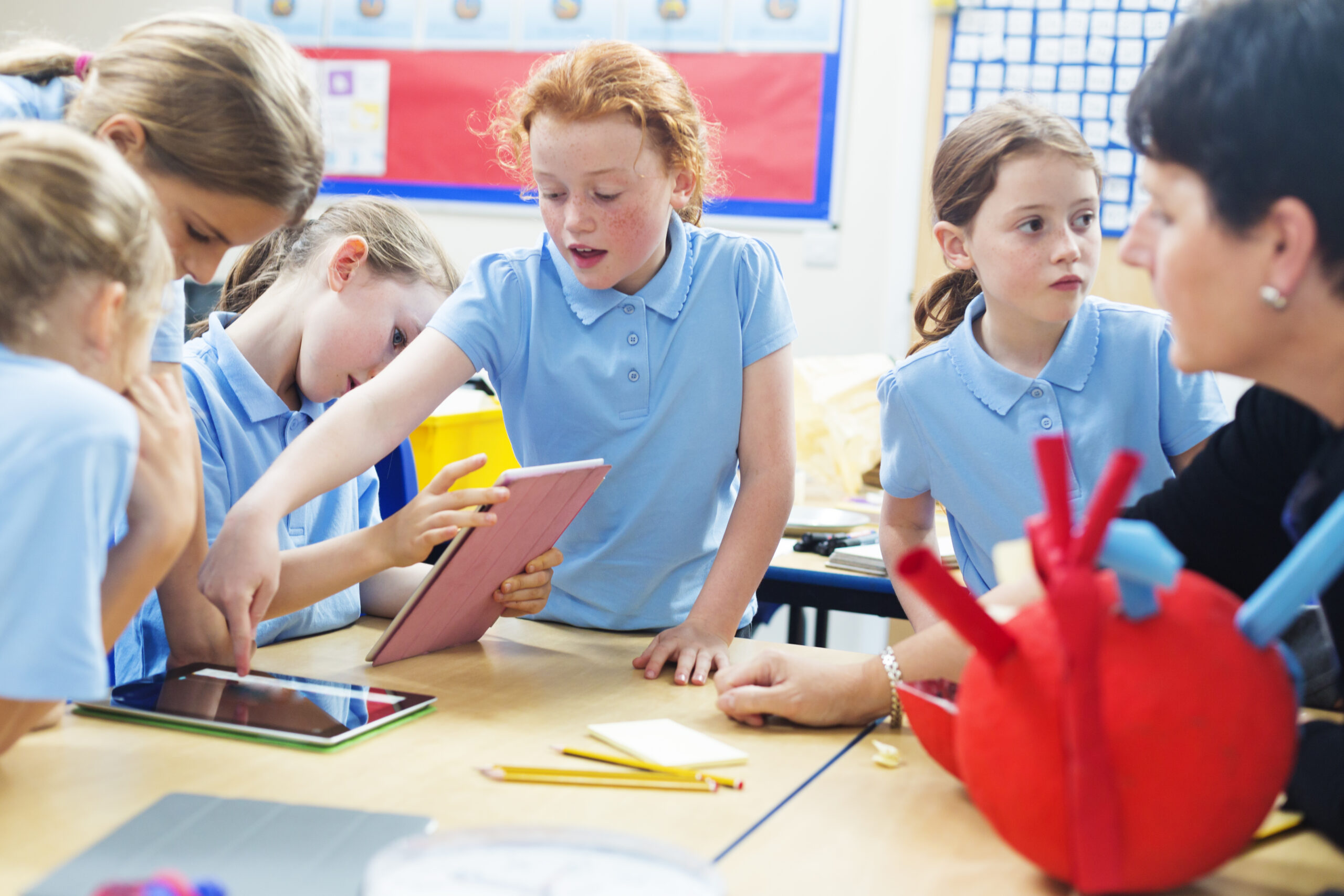 School children studying with tablet computers
