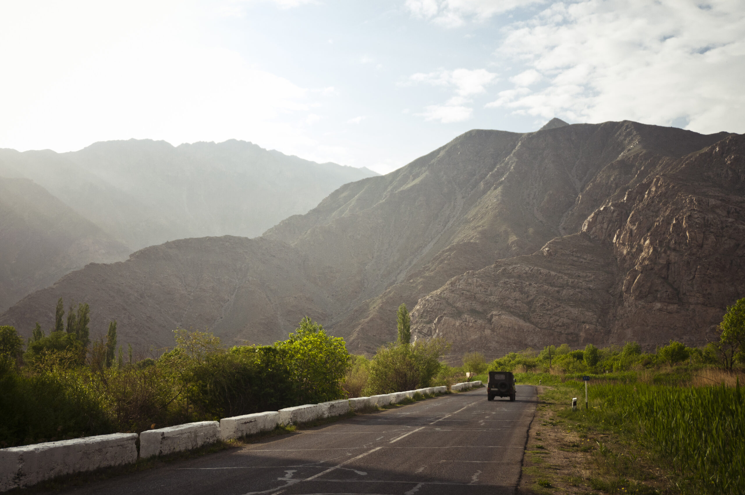 Landscape shot of the road between the city of Meghri (southern Armenia) and the Iranian border which is few kilometres south. In the region the border follows the course of the Aras River. There are arid mountains in the background. This image was taken during a journey by bicycle across Europe and Asia in 2013.