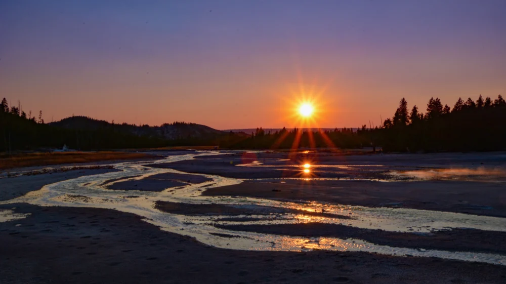 River meanders across a flat surface at sunset